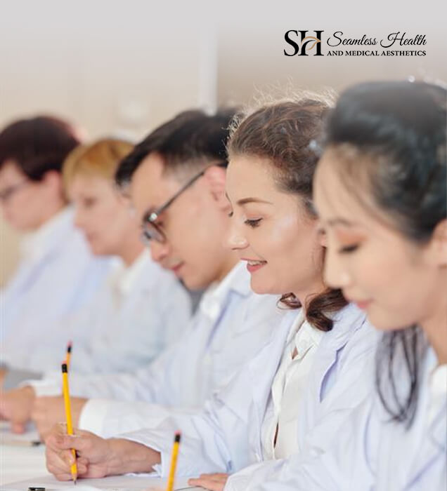 Healthcare professionals taking notes in an aesthetic medicine class