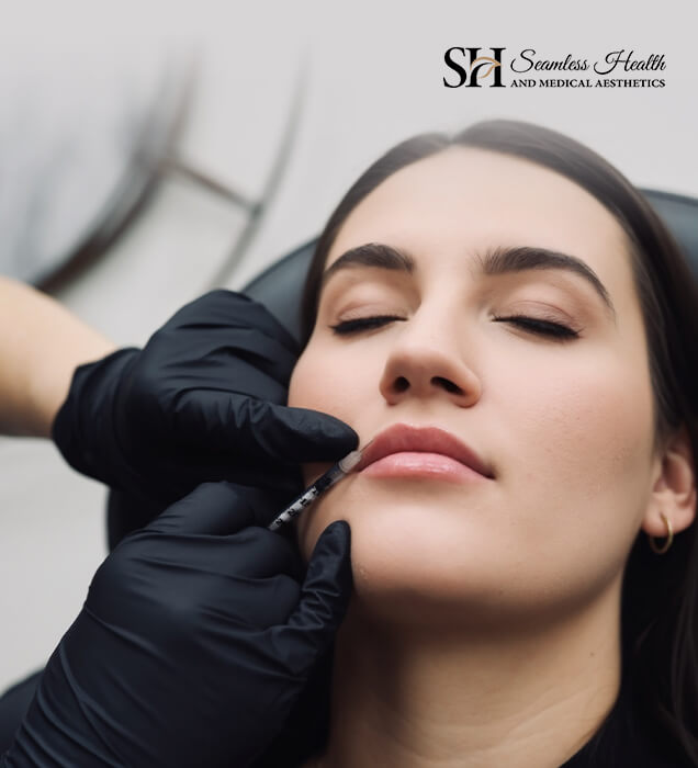Patient receiving a lip injection from a gloved injector