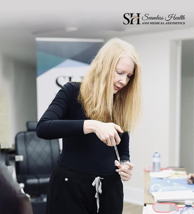 Seamless Health instructor preparing a syringe in the training room